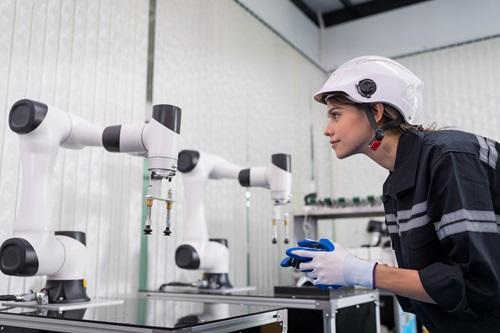 Female engineer training an AI powered robot Female engineer training an AI powered robot